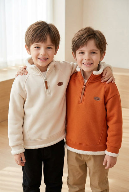 Two boys wearing warm winter sweatshirts in apricot orange and cream, featuring long sleeves and a casual design.