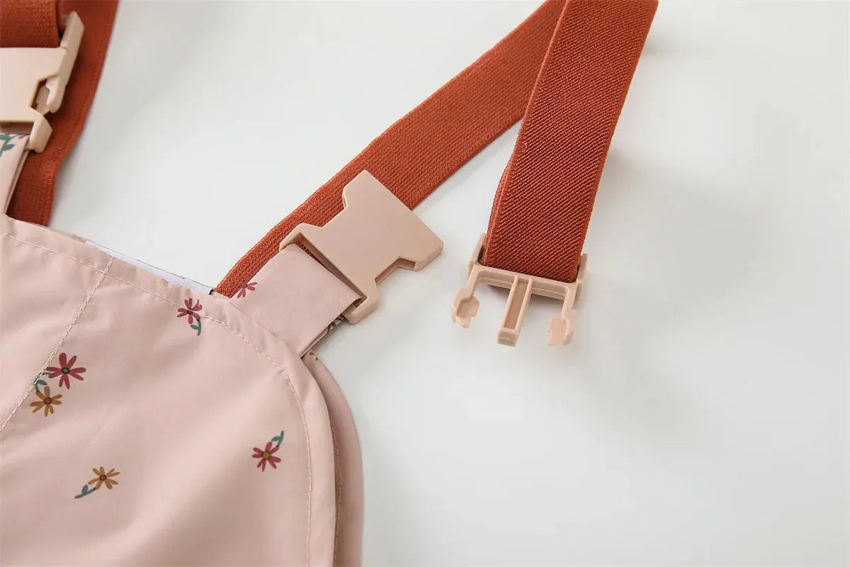 Adjustable buckle straps on HONEYKING pink floral bib rain pants