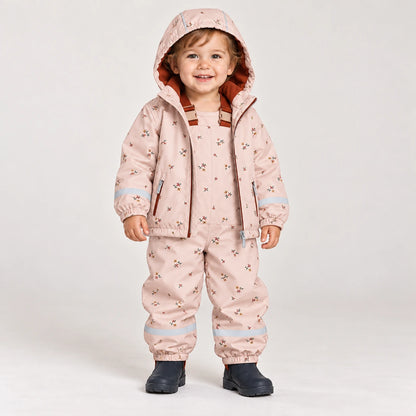 Toddler wearing HONEYKING fleece-lined rain jacket and bib rain pants in pink floral print