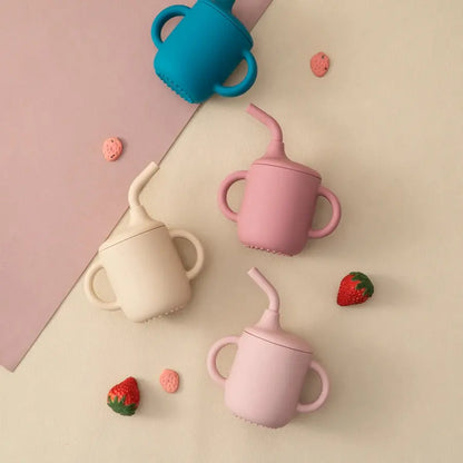 SipEase silicone sippy cups in teal, pink and beach sand with strawberries
