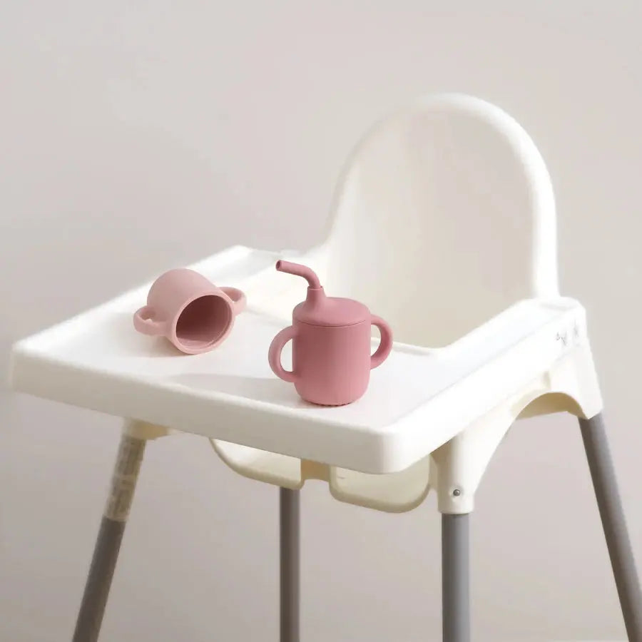 Two pink SipEase sippy cups on a high chair tray